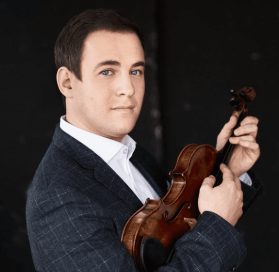 an image of a man holding a violin