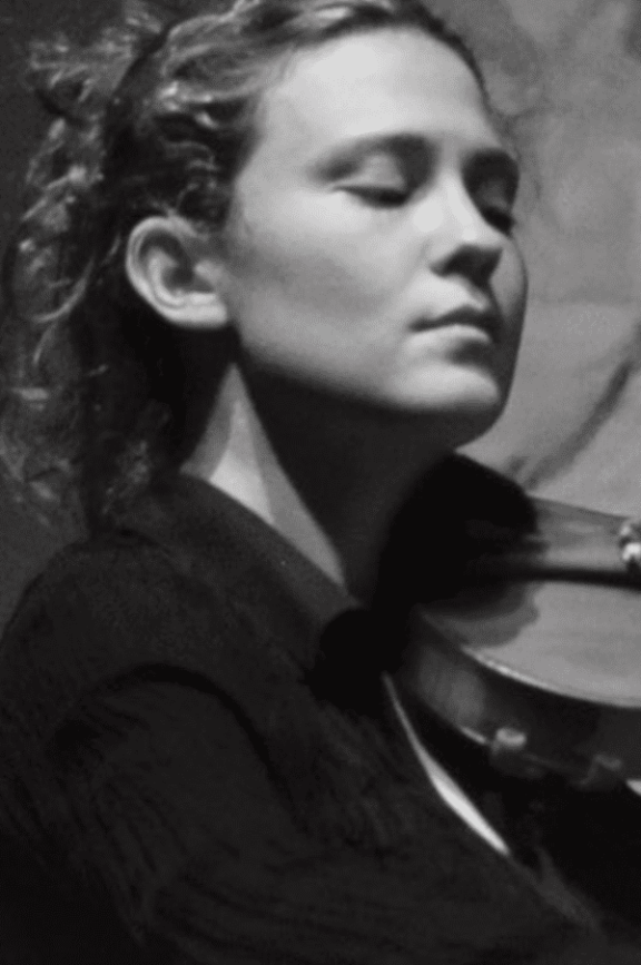 a black and white image of a woman playing the violin