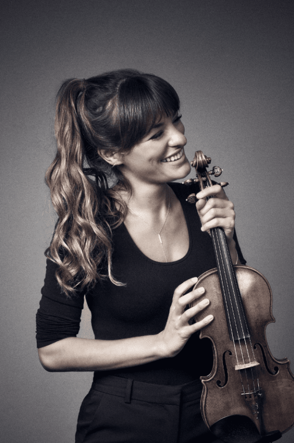 an image of a woman holding a violin