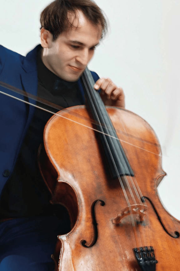 an image of a man playing the cello