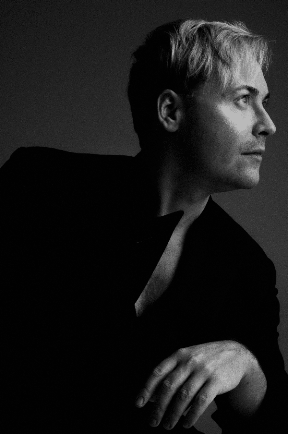 a black and white image of a man looking to his left