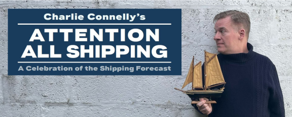 an image of a man holding a model ship
