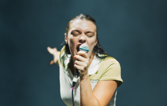 a girl singing into a microphone 