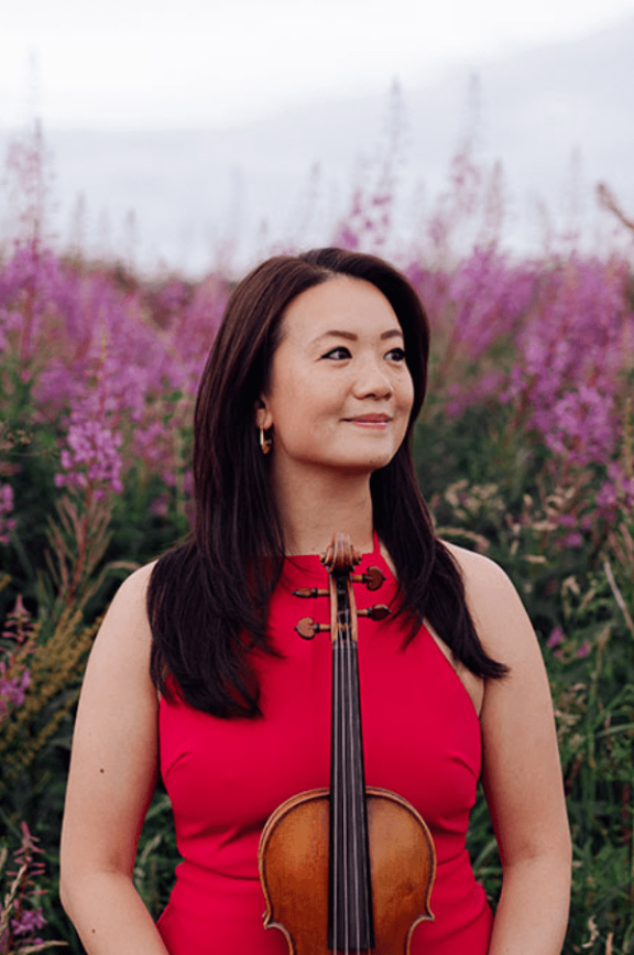 an image of a lady wearing red and holding a violin