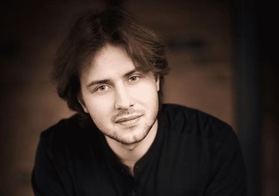 a sepia image of a man in a black shirt