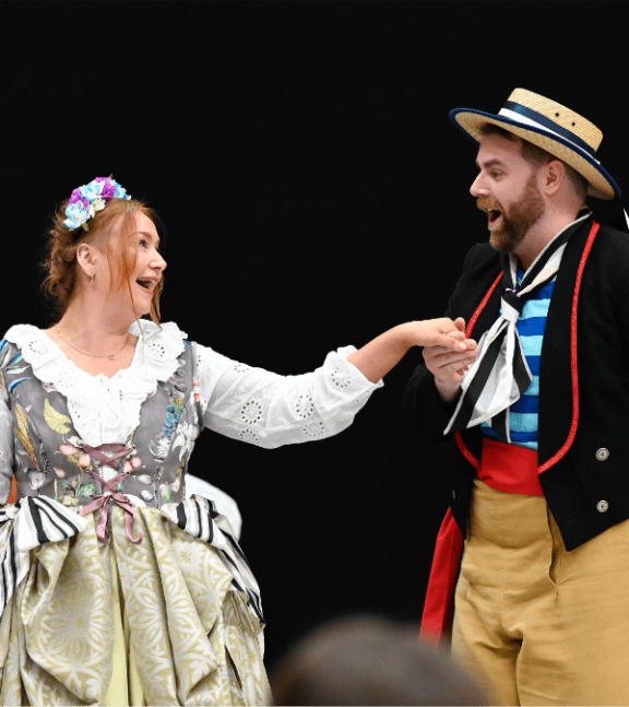 2 opera singers on stage sing to each other