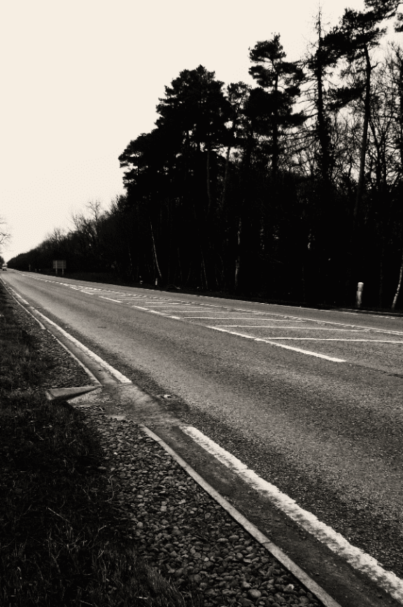 An eery road in black and white