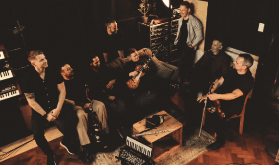 the members of Skerryvore sitting together with their instruments