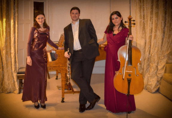 The Zemlinsky Trio stand holding their instruments