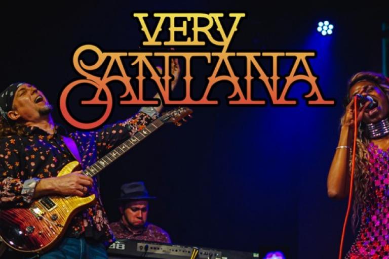 A man plays guitar on stage whilst a woman sings next to him with the writing 'Very Santana' in yellow across the picture.