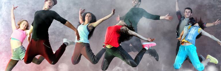 A group of dancers jumping.