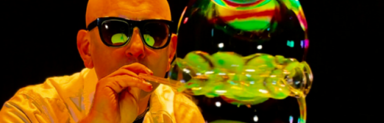 an image of a man blowing bubbles