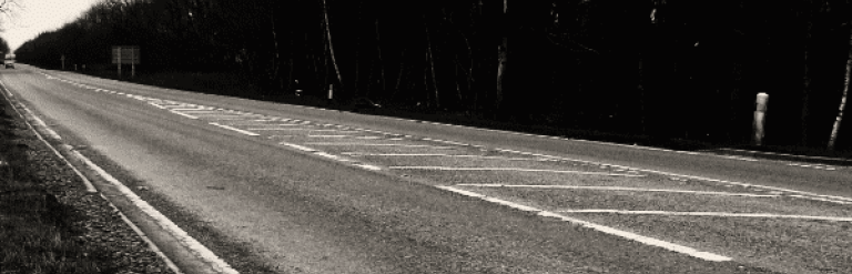 An eery road in black and white